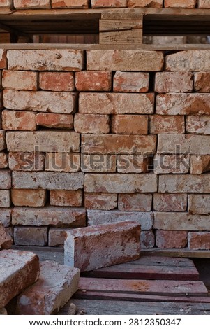 Old brick infront of pile of bricks