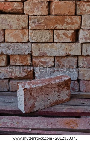 Old brick infront of pile of bricks