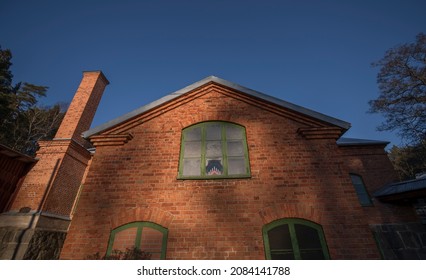 Old Brick Mill With Chimney With Frozen Windows, A Christmas Candlestick A Sunny Autumn Day In The District Bromma Of Stockholm, Sweden 2021-11-30