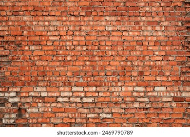 Old brick red wall, brickwork from an old brick in rustic style. Structure and pattern of destroyed stone grunge wall.  Retro style background. Copy space. 