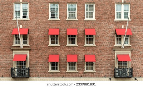 Old brick residential building facade with red window awnings, Boston, Massachusetts, USA - Powered by Shutterstock