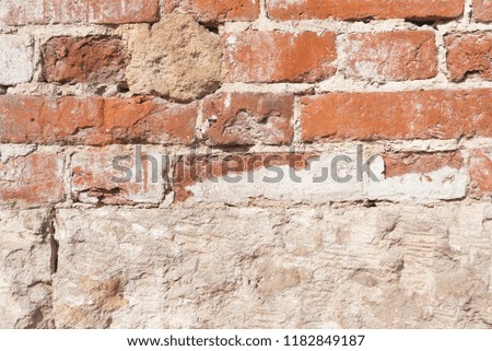 Old brick wall background with scrapes and cracks