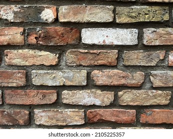 Old brick wall background, brick wall texture, structure. old broken brick, cement joints, close-up. crumbling from old age. construction, repair. concept of devastation, decline. High quality photo