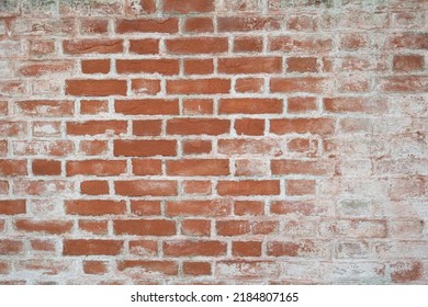 Old Brick Wall Covered With Remains Of Lime Plaster.