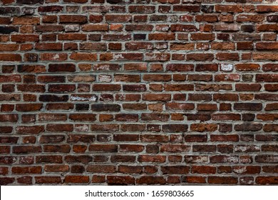 Old brick wall with devastating bricks