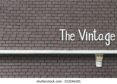 Old Brick wall texture background with with a word Vintage