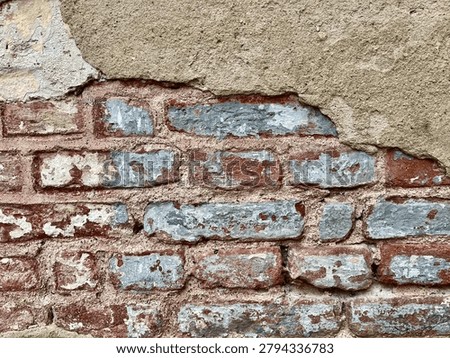 Old brick wall texture with peeling plaster and weathered surface