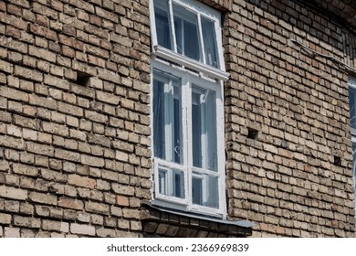 Old brick wall with windows.  empty building facade