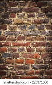old brickswall, vertical background with black vignette borders 