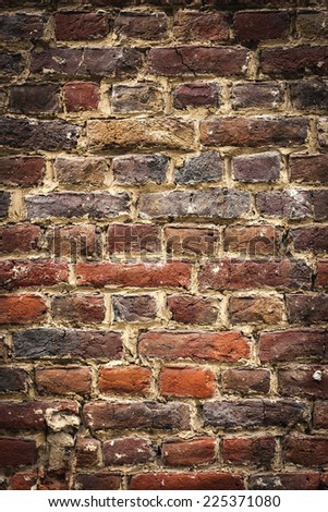 old brickswall, vertical background with black vignette borders 
