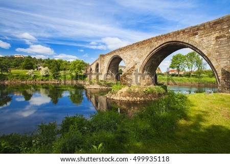 Old bridge with arches, turrets and buttresses crosses the Forth in Stirling, Scotland, scene of the historic Battle of Stirling Bridge where Scots led by William Wallace defeated the English in 1297.