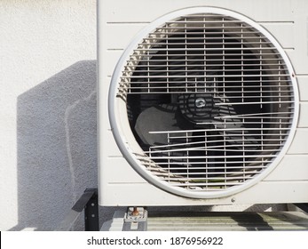 Old And Broken Air Conditioner Compressor Unit On White Wall At Outside Of House. 