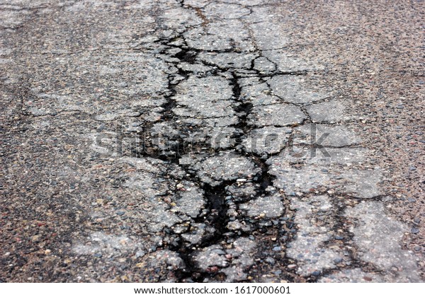 a old broken asphalt\
road