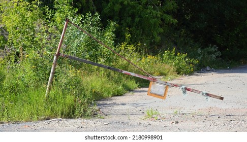 An Old Broken Barrier On An Abandoned Road