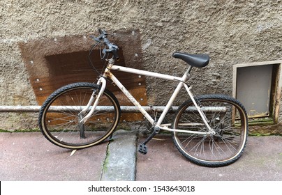 Old Broken Bike At The Wall