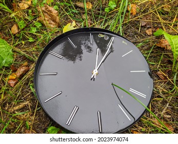 old and broken black clock in the forest in rainy time