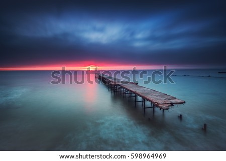 Old broken bridge in the sea, long exposure sunrise shot