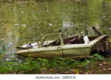 Old Broken Car After Accident Is Stuck In Dirty Ditch