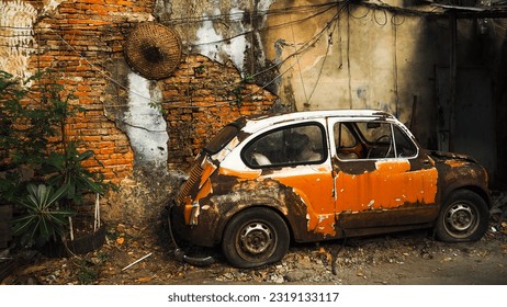 An old broken car parking at old brick wall - Powered by Shutterstock