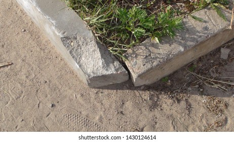 old and broken concrete curb in the daytime in summer - Shutterstock ID 1430124614