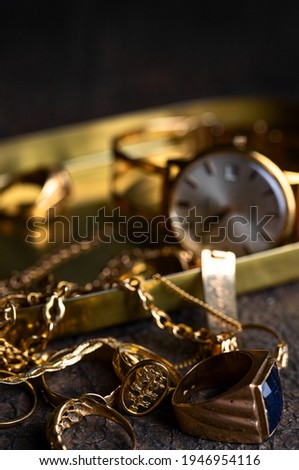 Old and broken jewelry, vintage watches on dark background. Sell  gold  for cash concept. 