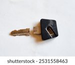 Old broken motorcycle key on a white background