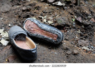 Old Broken Neglected Dusty Shoes In The Ground Waiting For A Chance To Reborn