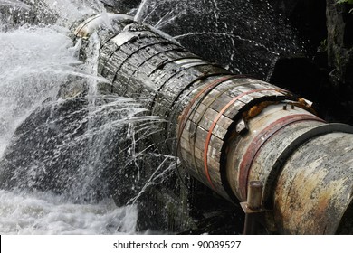 An old broken pipe that leaks water in all directions.