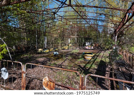 Old broken radioactive  cars in amusement park. the most famous ghost town Pripyat near Chernobyl and Nuclear Power Plant. exclusion zone. Ukraine.
