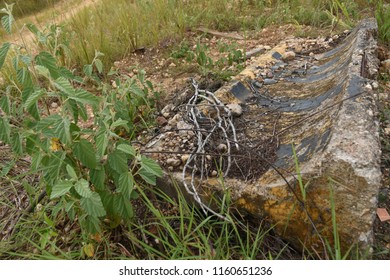 An Old Broken Road Barrier Beside The Road