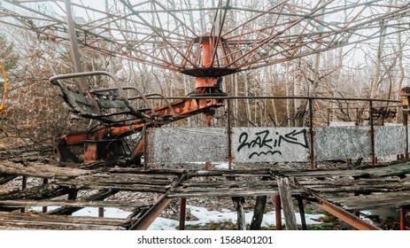 Old Broken Rotten Radioactive Carousel Abandoned Among Vegetation And Dirt In The City Of Pripyat, The Chernobyl Disaster, Ukraine, Kiev Region