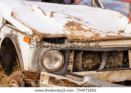 Old broken, rusting car.