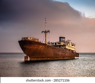 old broken ship agrounded near Lanzarote seashore, Canary Islands, Spain - Powered by Shutterstock