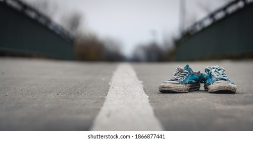 Old Broken Shoes On The Middle Of A Lonely Road