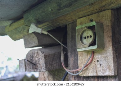 An Old Broken Socket On A Wooden Base