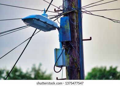 Old Broken Streetlight On Rotten Pole