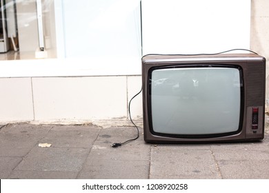 An Old Broken TV Left On The Street. High Angle View