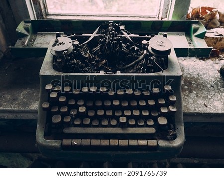 An old broken typewriter, forgotten in an abandoned office, a thick layer of dust covers the surface of the device, vintage atmosphere