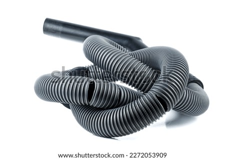 Old broken vacuum cleaner hose isolated on a white background