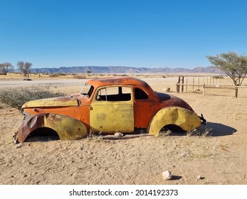 An Old Broken Vintage Car Thrown In A Desert