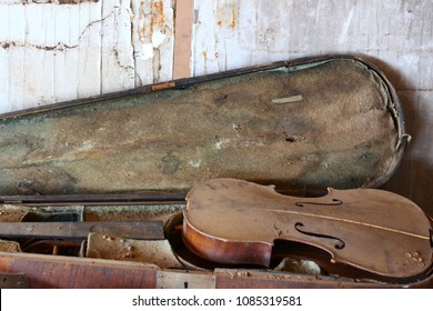 old broken violin inwooden case full of dust