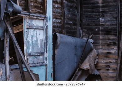 An old, Broken Window Frame on dilapidated wooden wall of an abandoned shack house at Paragkes Beach, Vouliagmeni, Athens
