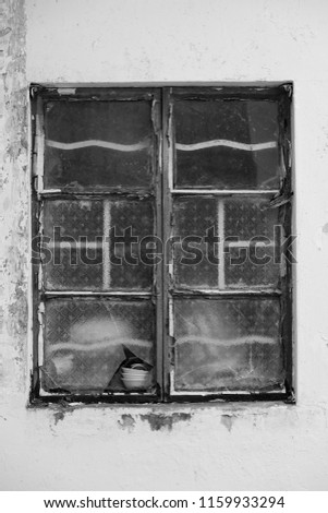 Old broken window on an abandoned old building (Black and White)
