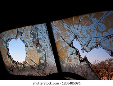 Old Broken Windsheild Of A Deserted Car, Looking Out On To A Desert Landscape