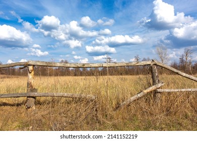 old broken wooden fence on dry grassland under nice sky with clouds. Take it in Ukraine - Powered by Shutterstock