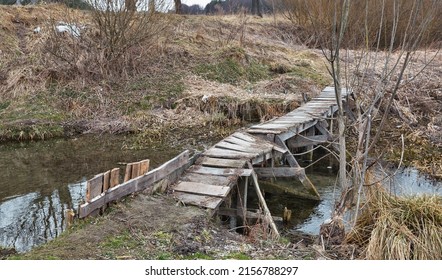 Old Broken Wooden Footbridge Over Ikva River In Western Ukraine.