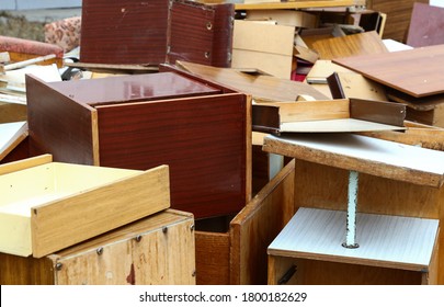 Old Broken Wooden Furniture On Waste Dump Site For Recycling, High Angle View