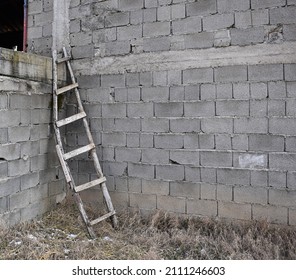 Old Broken Wooden Ladder At Wall