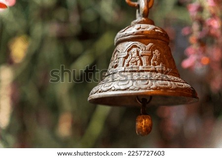 Old bronze bell in indian temple with blur background. Hindu temple brass bell hanging in gold color