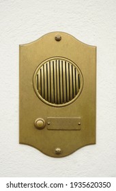 Old Bronze Door Intercom Buzzer. Vintage Golden Buzzer On A White Concrete  Wall